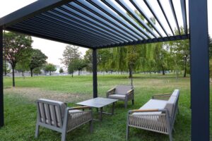 Close up of a louvered aluminum pergola in a yard